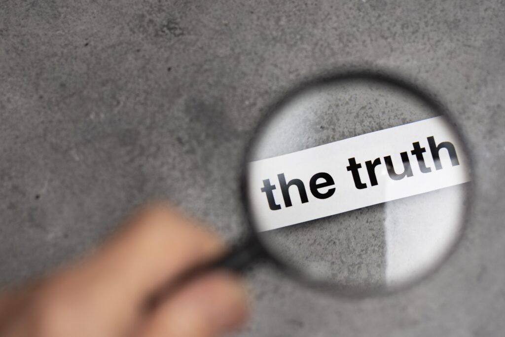 Magnifying glass with the words "the truth" zoomed in
