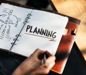 Planning strategy in notebook with flowchart.
