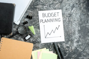 Budget planning paper with graph on a desk with office supplies