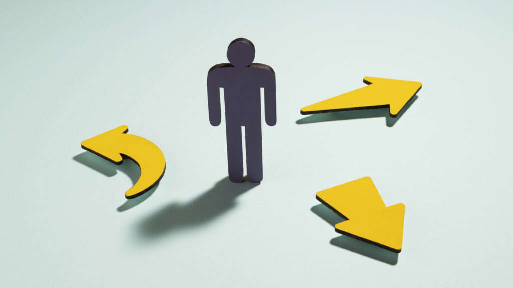 Person standing in the center with three arrows pointing toward them from different directions.